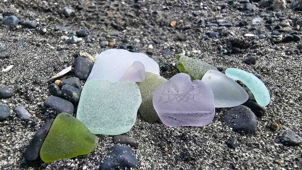 Green and purple sea glass on a Vancouver Island beach